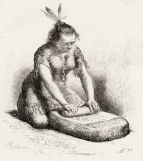 A native Guayan woman crushing grain.