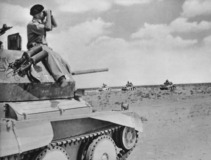 British Commander of a light calavary tank keeping a look out as his unit advances.