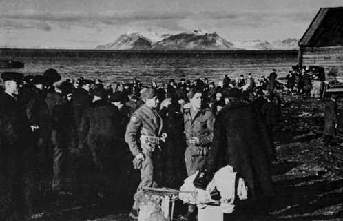 Norwegians waiting to be taken aboard British vessels in the late evening in Spitzbergen.