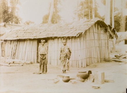 Ghanaian couple outside their hut
