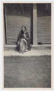 Seated woman in sari during railway outing