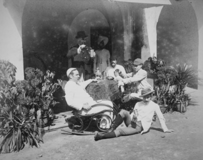 Group of European men relaxing outside building in Calcutta
