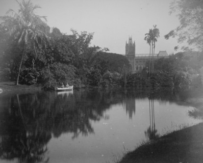 Scene showing rowing boat on a river and tropical gardens in Calcutta