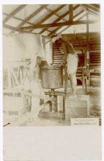 Two rubber factory workers with machine equipment