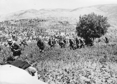 Arab Army of Liberation soldiers march across fields near Castel, east of Jerusalem.