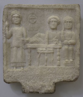 Goddess Bendis and a family group: bust of a child and feasting husband and wife. Inscription in