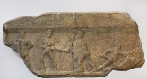 Gladiator fight. Greek inscription: ""Leukaspis"" (name of the gladiator). Fragment of a marble