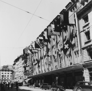 Frontage decorated with flags;  end of second world war; 1945.