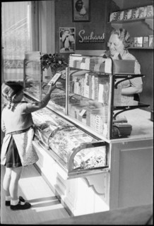 Girl buying chocolate; around 1943.