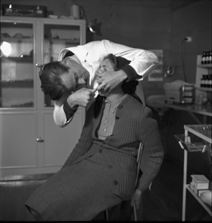 Dentist with patient, in the 40s
