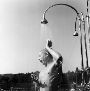 Young man taking a shower in the outdoor-swimmingpool Dolder in circa 1950