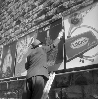 Poster advertising, man placarding, aound 1950