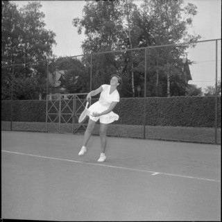 Jeannette Altwegg playing tennis, ca. 1955