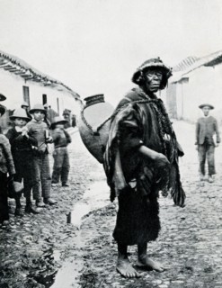 This photograph, dating to 1914 or earlier, shows an Indian water carrier in Sicuani, a town in