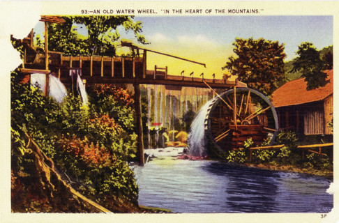 Pictured in this early 1930s postcard is an old water wheel in the ""heart of the mountains"" in