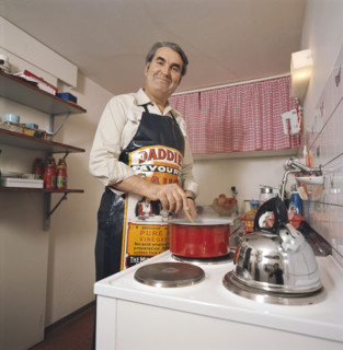 Pierre Arnold 1976 in his kitchen, cooking.