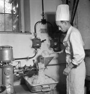 Cook at work in large kitchen; soup kitchen; 1941.