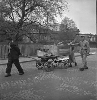 Men gathering non-ferrous metal, handcart; 1942.