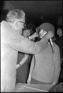 Woman soldier getting helmet, armoury Kreuzlingen 1964.