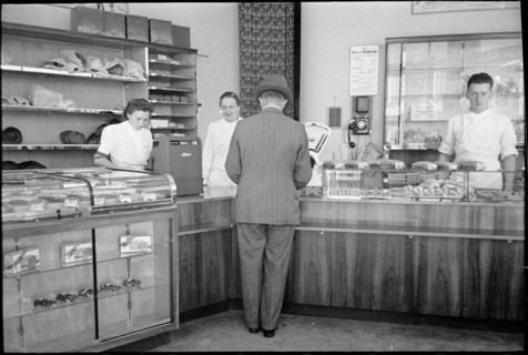 Customer in baker's shop; around 1940.