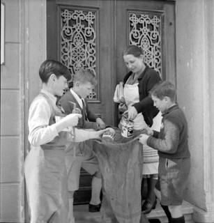 W K 2: war economics; young people collecting material to be recycled.
