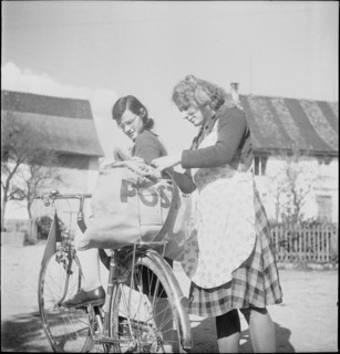 WW2 : farming camp; girl, young woman, mail, postal bag on bicycle, 1943.