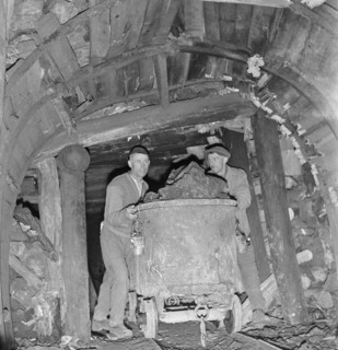Asphalt mine; miners pushing mine car; 1941.
