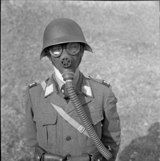 Swiss soldier in gas mask and helmet 1958