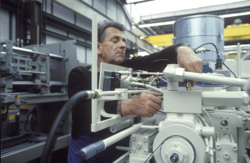 Worker assembling injection molding machine 1986
