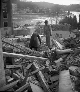 WW 2: bomb airdrop, dropping; couple looks for belongings in ruins of home, Schaffhausen 1944
