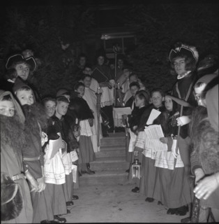 Children in historical costumes wait for Santa Claus in 1941