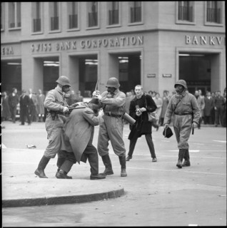 Policemen bashing demonstrator; 1961
