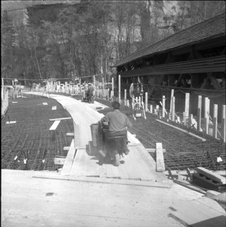 New Wynigen bridge under construction, next to the old wooden roofed bridge; 1960