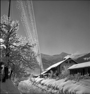 Lenk, iced over circuit line in snowy landscape; 1946