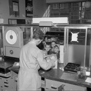 Postal worker accepting parcels from children, Zurich 1956