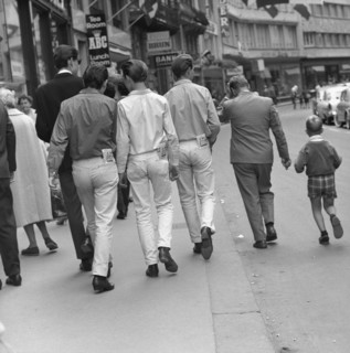 Young people looking in their pockets, 1960