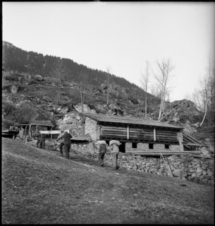Urnerboden: people searching among the remains of buildings destroyed by an avalanche, 1940