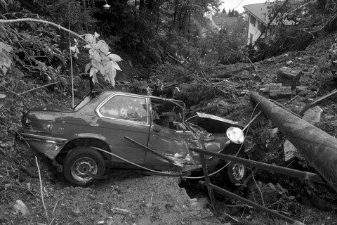 Flood in Ticino, Switzerland 1981: People watching at destructed house