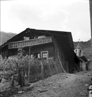 Muhen, man and boys in front of traditional thatched house, 1942