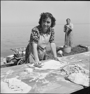 Women scrubbing laundry with a brush; washing at Lake Constance, 1944