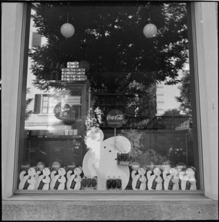 Product advertising, CocaCola advertising in shop windows; 1952