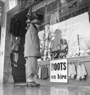 Grindelwald, man looking at shop window; 1950.