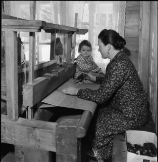 Woman with child at the loom, 1945.