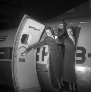 Swissair hostesses waving out of airplane door 1953.