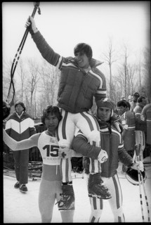 Olympic games Lake Placid 1980, downhill: Podborski and Wirnsberger carrying winner Stock on their