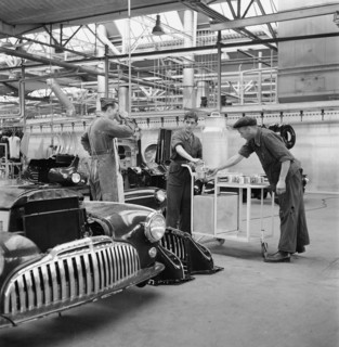 Factory workers have a break; assembly hangar; General Motors 1946.