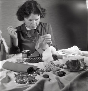 Woman making a Santa Claus doll in 1944.