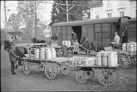 Milk cans; loading in goods train; 1941.