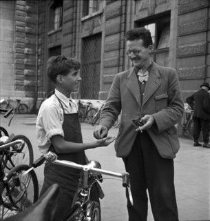 Basle, client paying for the cleaning of his bicycle; 1941.