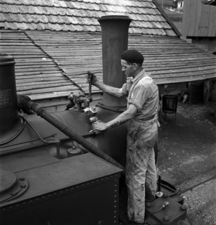 Mechanics repairing a steam locomotive in Les Brenets 1946.